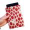 A hand holding a  Kindle sleeve with snap to protect Kindle e-readers made with a pink back ground with red and white strawberries.